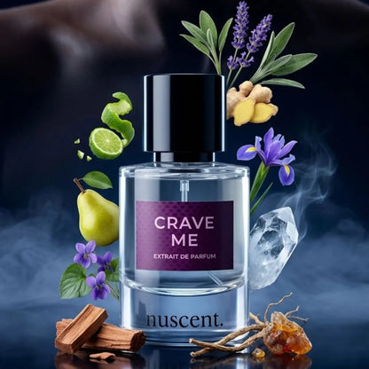 Crave Me Extrait de Parfum bottle centered with fragrance ingredients arranged around it including fresh ginger, lavender, sage, pear, iris, cedarwood, vetiver and sandalwood on dark blue background