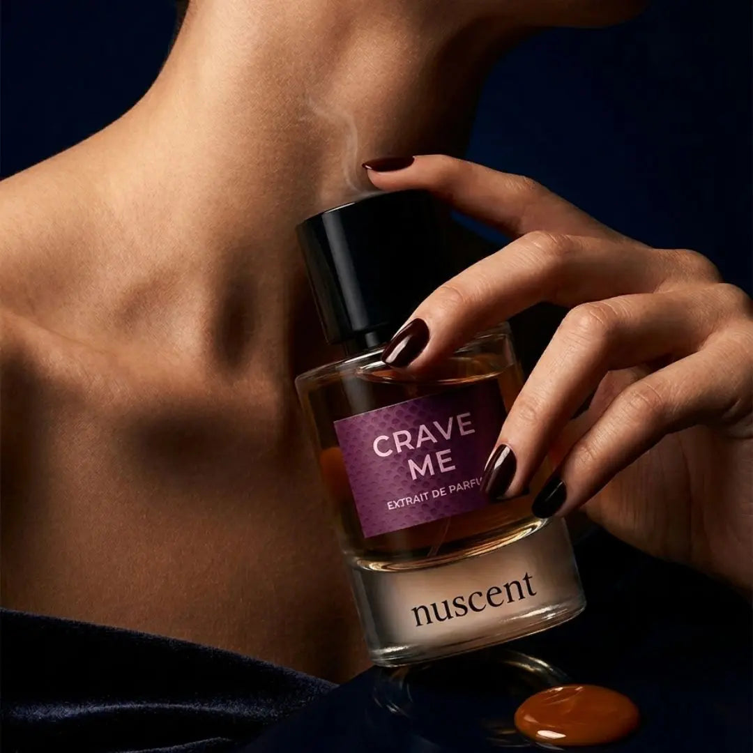 Woman applying Crave Me Extrait de Parfum fragrance to neck showing luxurious application ritual and skin-warm finish