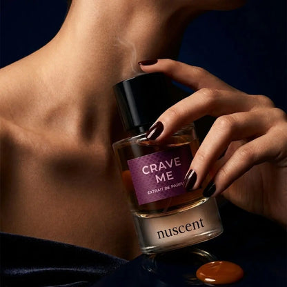 Woman applying Crave Me Extrait de Parfum fragrance to neck showing luxurious application ritual and skin-warm finish