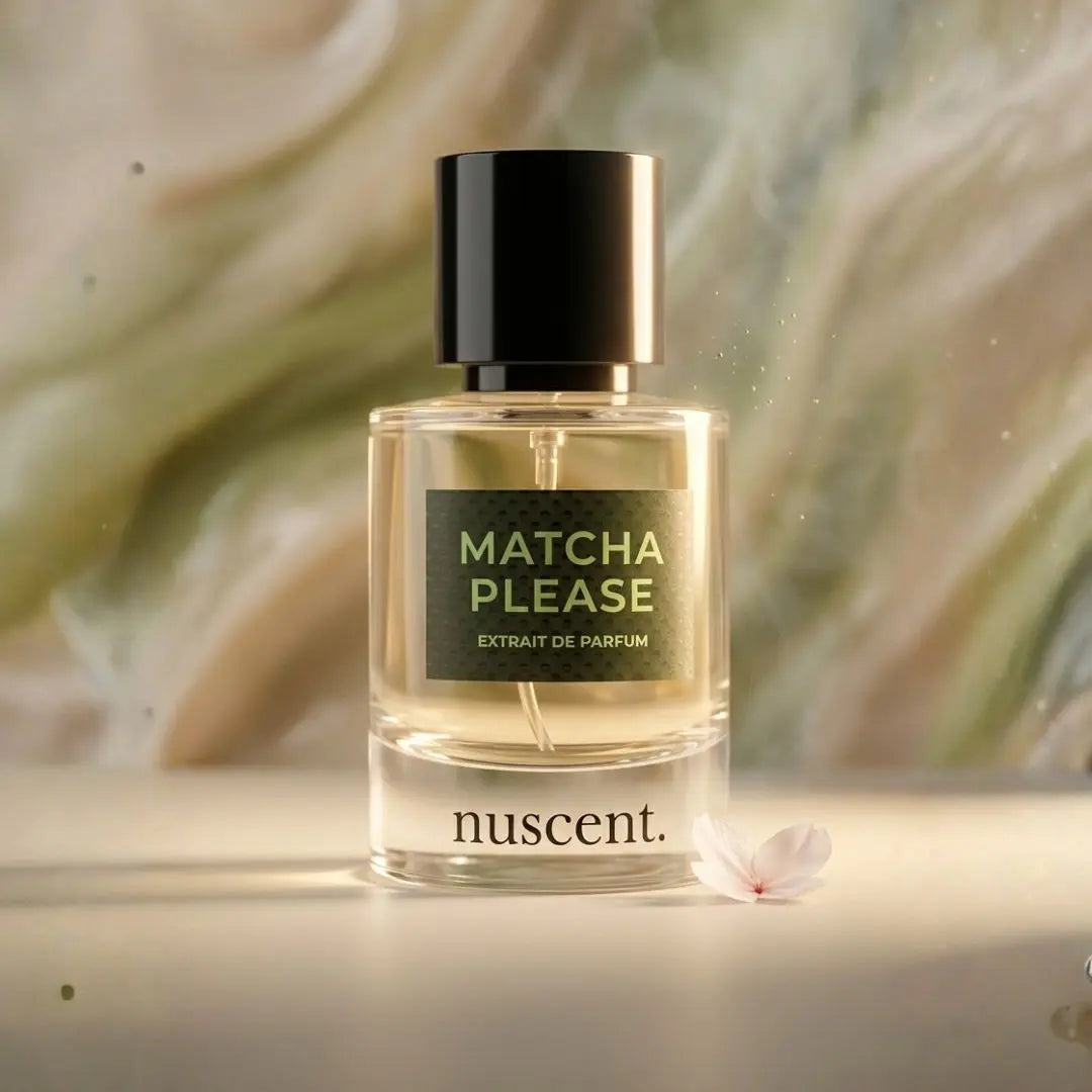 Matcha Please Extrait de Parfum bottle displayed on neutral beige background with soft white flower accent showcasing fresh green fragrance
