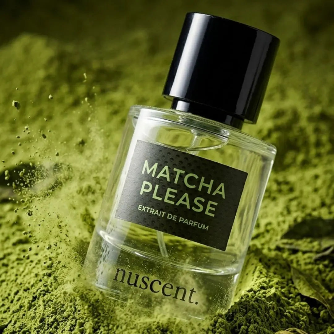 Matcha Please Extrait de Parfum bottle resting on vibrant green matcha powder with artistic texture and depth composition