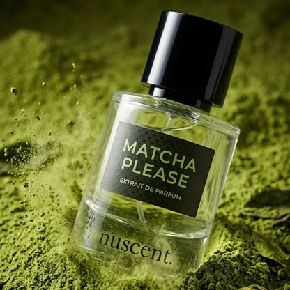 Matcha Please Extrait de Parfum bottle resting on vibrant green matcha powder with artistic texture and depth composition