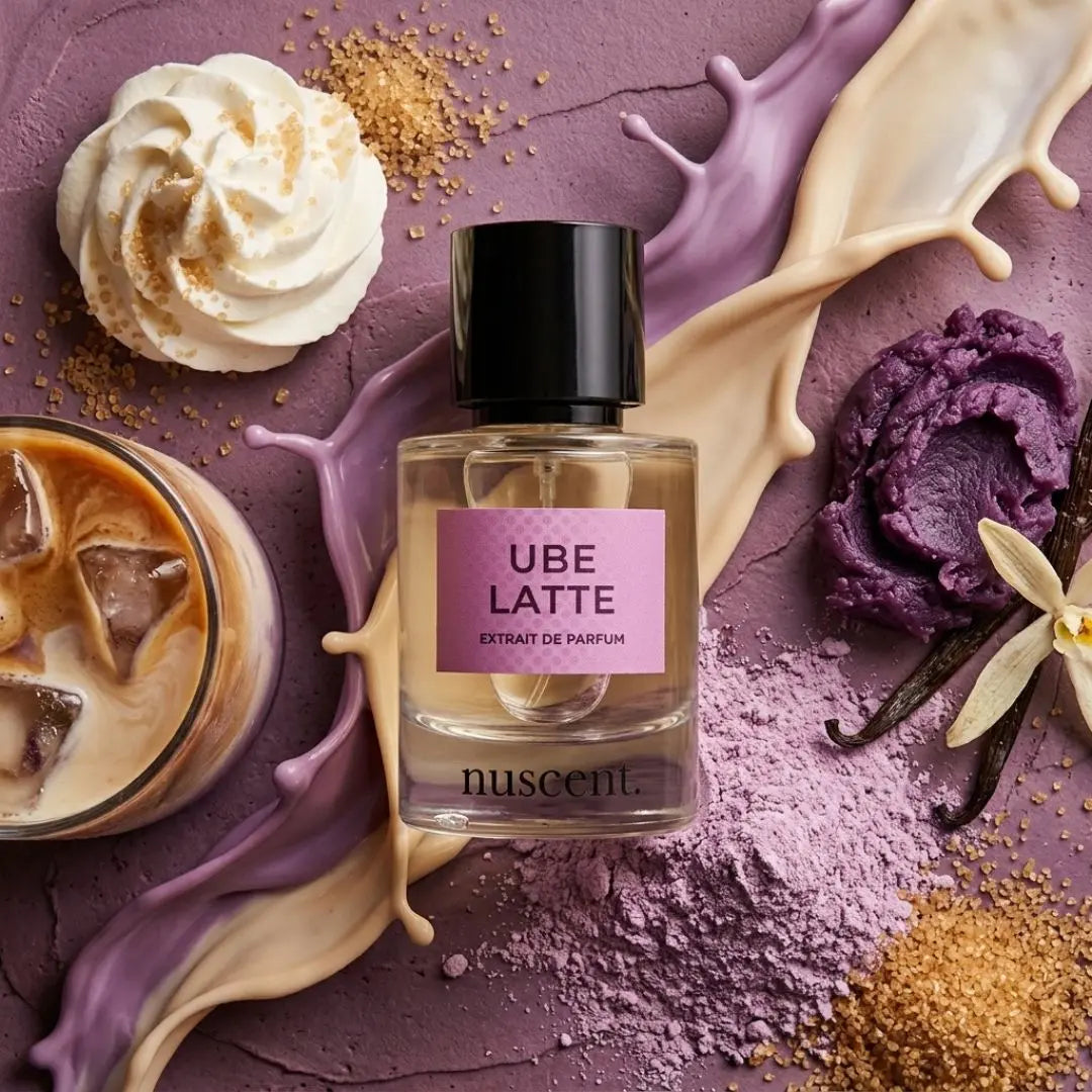 Ube Latte gourmand fragrance bottle with artistic splashes of purple liquid, cream, and vanilla pod ingredients