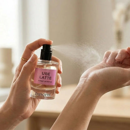 Woman spraying Ube Latte Extrait de Parfum fragrance on wrist